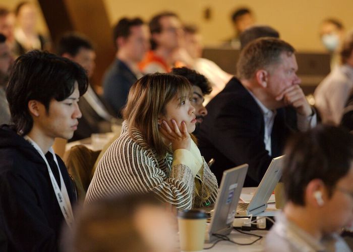 audience sitting and listening to a presentation