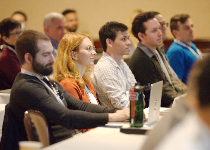 people listening to the presentation at a conference