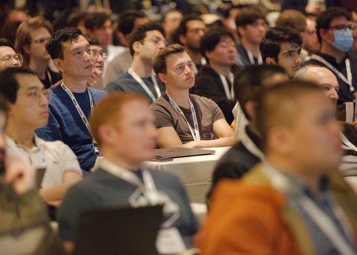 people in a conference room listening to the presentation