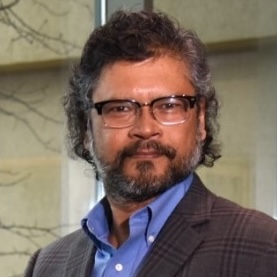 a man with long hair and beard wearing glasses