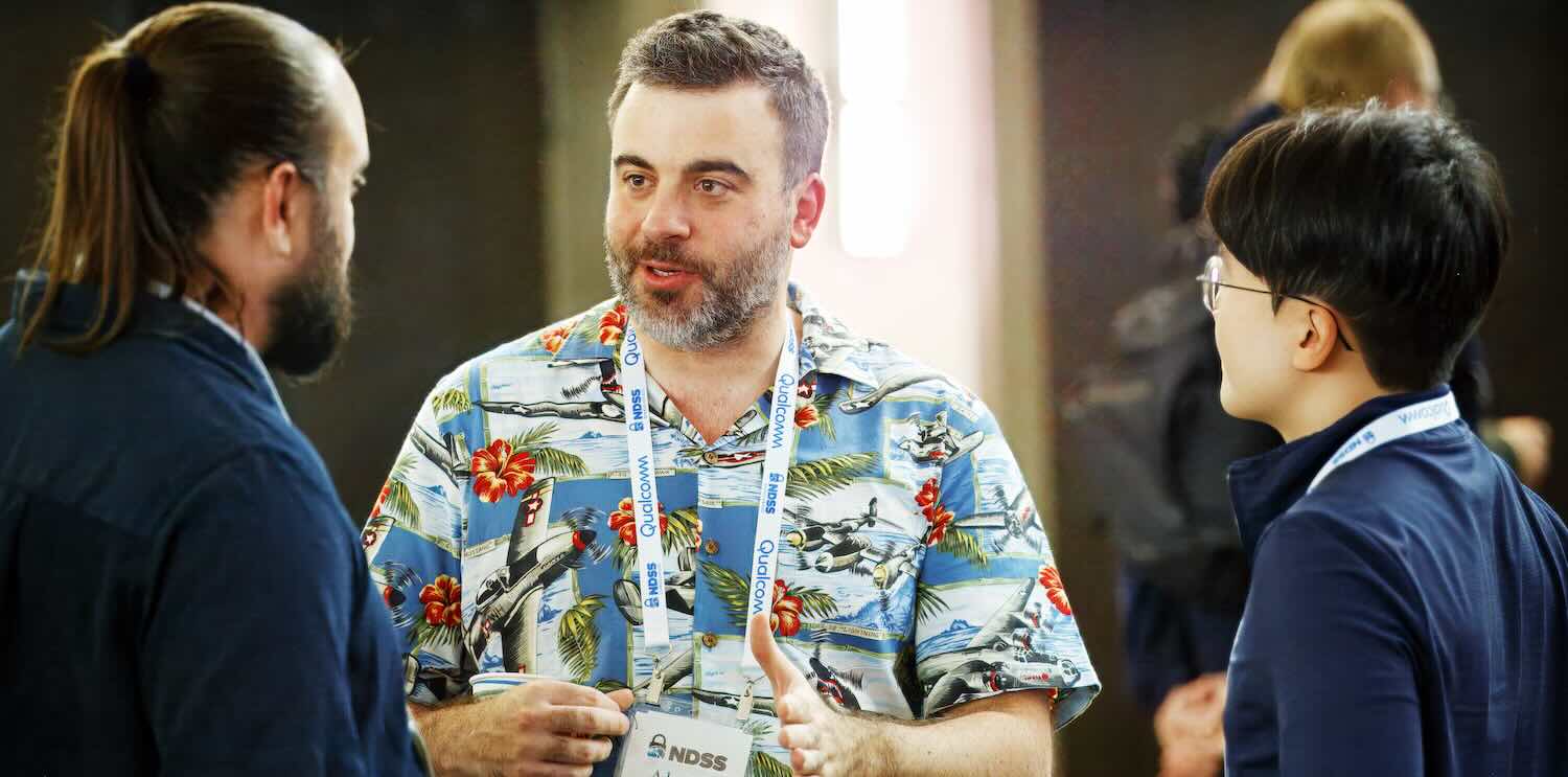 Two men standing on a rooftop, gazing intently at an unseen object