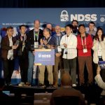 a group of people on the stage applauding