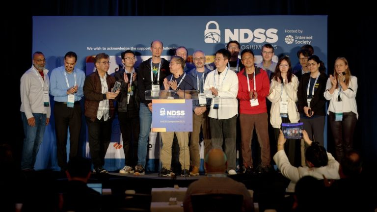 a group of people on the stage applauding